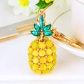 Golden pineapple keychain pendant featuring yellow opal stone and sparkling green leaf gems - Yellow Cat Eye Pineapple