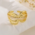 Gold plated geometric open ring with zircon pavé stones on a stone display - Intertwined Bow
