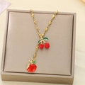 Detailed macro view of red apple and cherry charms on a gold-tone titanium steel chain - Apple and Cherry Double Pendant Style (KN292066-Z)