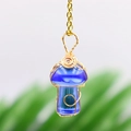 Handmade wire-wrapped mushroom pendant in deep blue stone with golden wire detail - Synth Blue Crystal Gold-tone