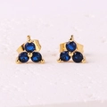 Minimalist clover stud earrings with faceted blue zircons in a golden setting - Sapphire Blue