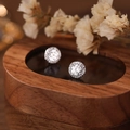 Sparkling round zircon stud earrings in S999 sterling silver on dark wood display - White Gold / Large