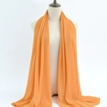Elegant bright orange chiffon hijab scarf displayed on a minimalist linen torso mannequin - 64