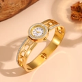 Close-up detail of an elegant gold stainless steel hollow rhinestone bangle watch. - Circle Hollow (F707) / Gold
