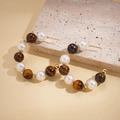 Detailed view of C-shaped earrings with alternating tiger eye stones and white pearls - Silver Pin-Coffee (Real Gold Plating)