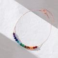 Detail of rainbow gemstone bracelet with 14K gold plating and lobster clasp on white leather - Anklet / Rose Gold
