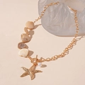 Detailed shot of ocean theme necklace with starfish, shell, and pearl on gold chain - Gold Starfish Necklace