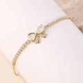 Elegant gold bow bracelet featuring water drop zircons and sparkling micro-pave crystals - White Butterfly A - Gold