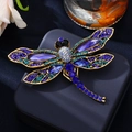 Golden dragonfly brooch with blue crystals and rhinestones on jewelry box display - Dark Blue