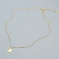 Elegante Halskette aus vergoldetem Silber mit feinem Muschel-Anhänger auf grauem Grund - 925er Silber / Gold