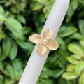 18K gold plated flower ring with striped petals and light pink pearl center on white stand - Striped Floral Pearl Style