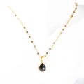 Double layer gold necklace with black pear shaped stone pendant on mannequin neck - Single Layer Black Necklace