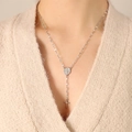 Silver Y-shaped cross necklace with Virgin Mary medal on model in beige sweater - 50+5cm / Steel