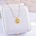 Golden rose relief necklace with small red gemstone pendant on white jewelry box - Flower with Red Rhinestone