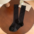 Knee-high black combed cotton socks with diamond knit texture and vertical ribbing details - One Size / Black