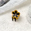 Petite pince à cheveux fleur bicolore jaune et noire avec un cristal scintillant central - Curcuma
