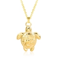 Detailed macro view of gold turtle pendant with 18k plating and embossed sea motifs - Pendant Necklace / Gold