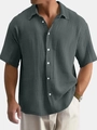Close-up of men's dark grey short sleeve cotton shirt with textured seersucker fabric - Gray