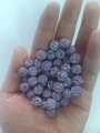 Lavender purple Shamballa beads with full sparkling rhinestones in a handful palm view - 10mm / Violet