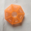 Weekly 7-day pill organizer in translucent orange with independent daily lids - Orange