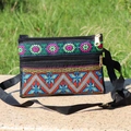 Ethnic crossbody bag with floral embroidery and adjustable strap on a natural background - Style 5