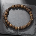 Detail of dark brown wooden bead necklace with turquoise spacers on stone texture - ZJ12523-Dark Brown Adjustable Wood Bracelet