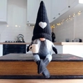 Nordic knitted gnome plush decor with heart hat sitting on a vintage book - Left Hand Coffee Female Gnome / Black