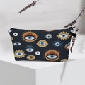 Macro view of blue travel toiletry bag with evil eye patterns on white geometric stand - Dark Blue Various Eyes