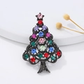 Detailed close-up of a vintage silver Christmas tree brooch with colorful rhinestones - Pearl and Rhinestone Tree