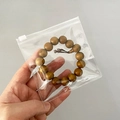 Brown wooden Buddhist prayer beads bracelet packed in a clear transparent PVC zip lock bag - Slider Bag 11*11cm
