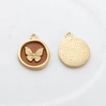 Detail of golden butterfly charm pendant with brown enamel and textured metal back - Orange