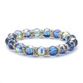 Sparkling blue 96-facet crystal bead bracelet with gold rhinestone spacers on white background - 10mm Blue
