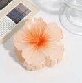 Macro view of gradient orange frangipani hair claw clip with acrylic resin petals - Plumeria Claw Clip Orange