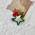 Handmade crochet star hair clip in white and green yarn with festive red bow accent - Green Edge Pentagram Hair Clip