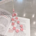Close-up of pink flower beaded phone strap with resin floral charms on magazine - Pink Flower Beaded Lanyard
