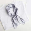 Silver grey satin square silk scarf knotted on a white T-shirt for minimalist styling - Silver