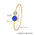 Detailed view of golden stainless steel open cuff bracelet with square blue glass stones - Gold Blue