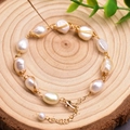 Handcrafted baroque pearl bracelet with gold wire wrapping on a natural wood background - Adjustable Baroque Freshwater Pearl Bracelet
