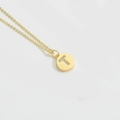Minimalist gold necklace featuring a round pendant with a sparkling diamond T initial - Letter T
