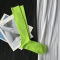 Vibrant green ribbed mid-calf socks with high elasticity displayed on magazines - Calf-length Tender Green