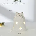 White ceramic bell-shaped Christmas ornament with star cutouts and warm glowing light - Wind Bell
