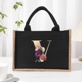 Black canvas tote bag with jute trim and floral gold letter V design on front - Bronze Floral Letter V