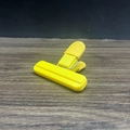Yellow plastic T-shape food sealing clip for snack bags on dark wood surface - Beige Small