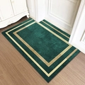 Deep green rectangular door mat with gold geometric borders on light wood floor - Cloister