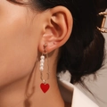 Golden paperclip earring with white pearls and red heart pendant worn on ear - Heart Pearl Paper Clip Earrings KC Gold (M-710)