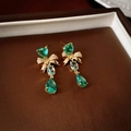 Macro shot of gold-plated tassel earrings featuring green zircon hearts and bow details - Green Bow Heart Style (S925 Pin)