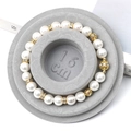 Elegant white pearl bracelet with gold hollow beads on a 16cm grey velvet display tray - Flocked Plastic / Grey Sizing Tray (16cm)