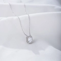 Detail of emerald cut zircon pendant on white satin with halo setting necklace - 925 Silver / White
