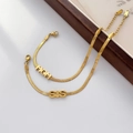 Detail of 18K gold snake chain bracelets with custom MOM and SIS letter pendants - MOM Bracelet