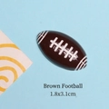 Detailed view of brown resin football flatback charm with white stitching for DIY jewelry - Brown Rugby